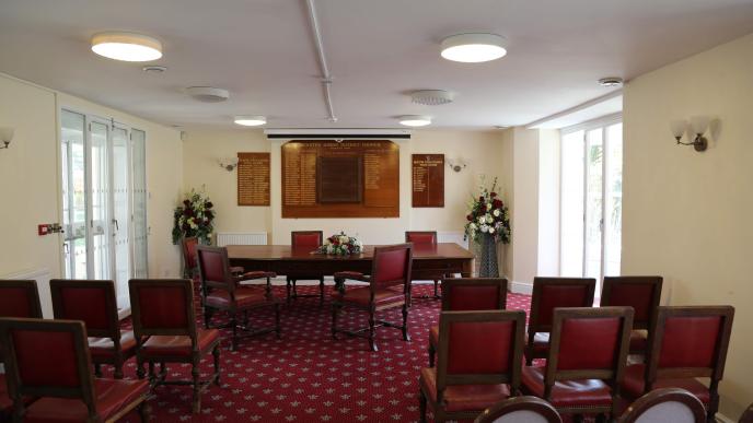 bicester ceremony room facing forwards with 5 empty chairs at the ceremony table