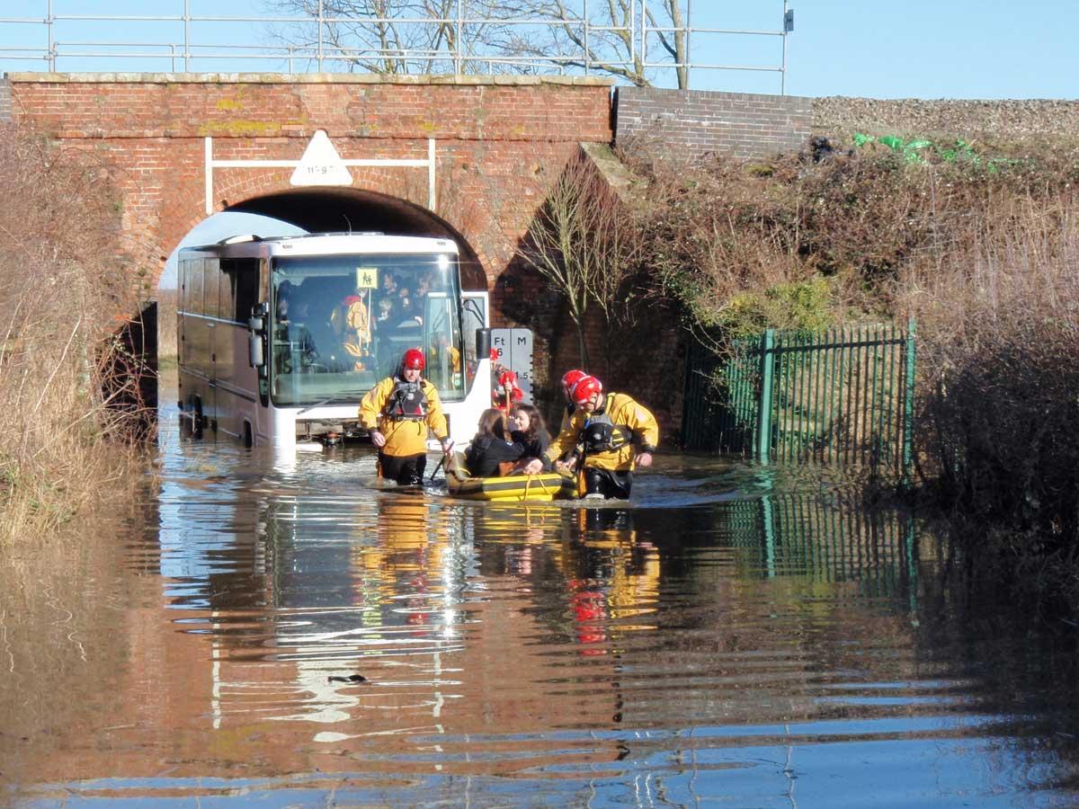 Council staff help people stranded on flooded road